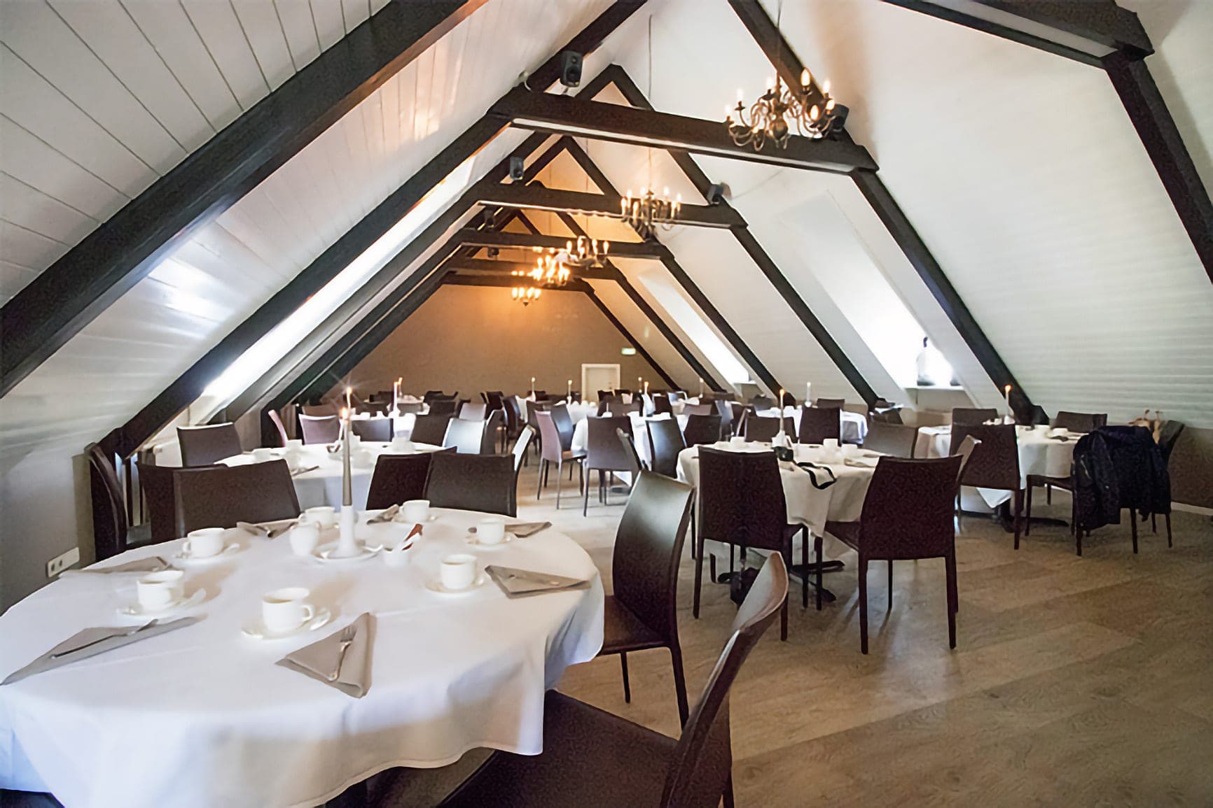 Kornhlaðan set with dining tables for a corporate event in Reykjavík